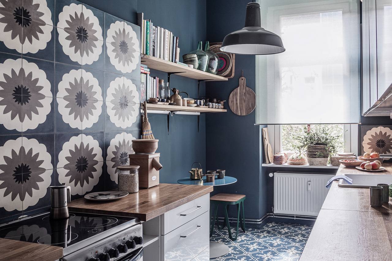 Küche mit blauen Boden und Wandfliesen und blauer Wandfarbe