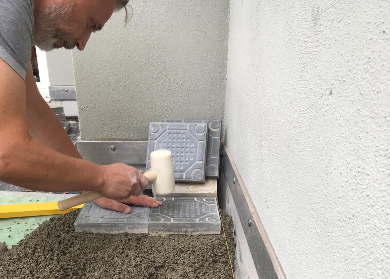 Laying concrete slab in outdoor area 