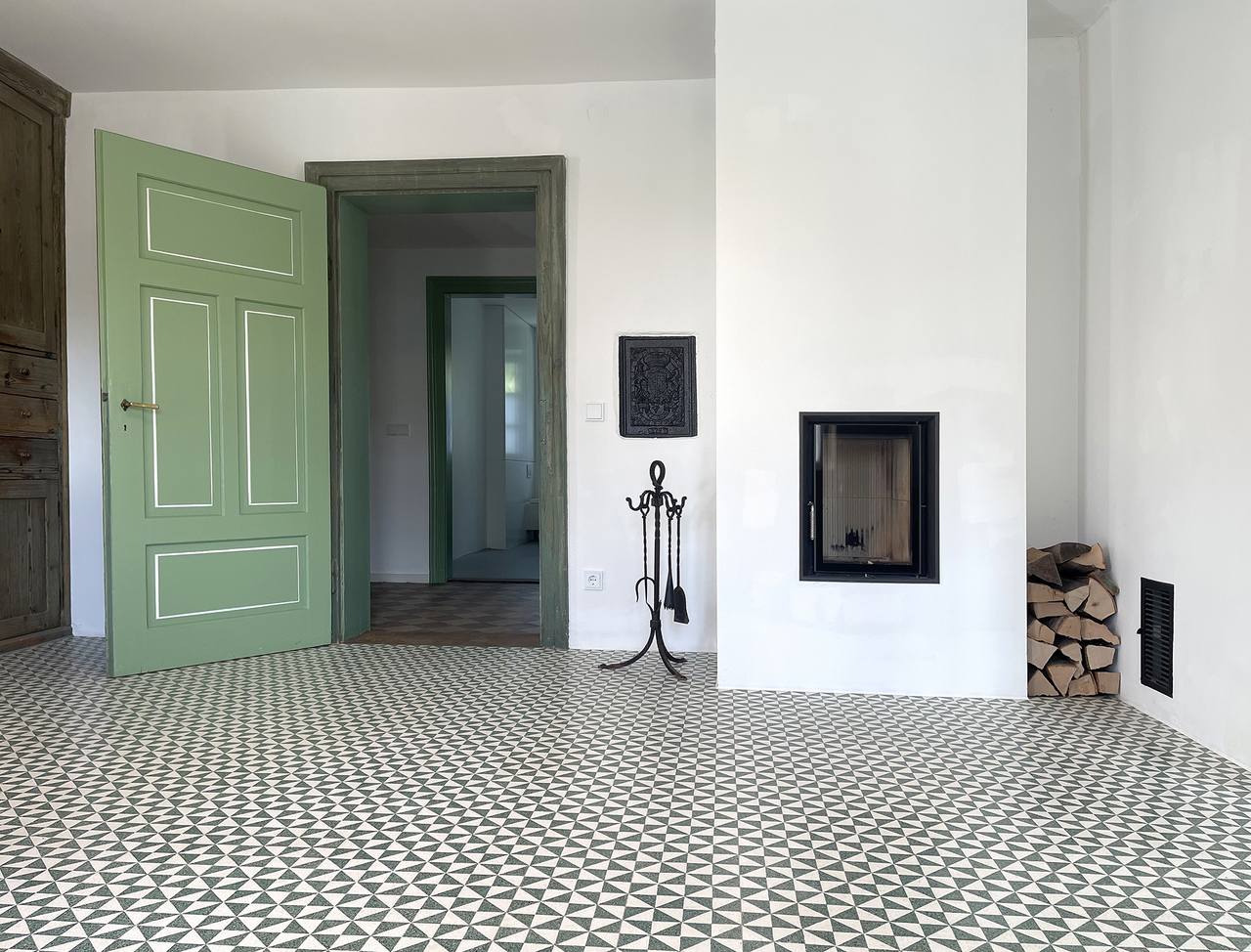 Bauernhaus mit Kamin und grüner Holztüre und VIA Terrazzoplatten