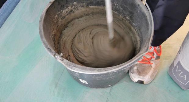 VIA Plattenkleber wird in Eimer angerührt 