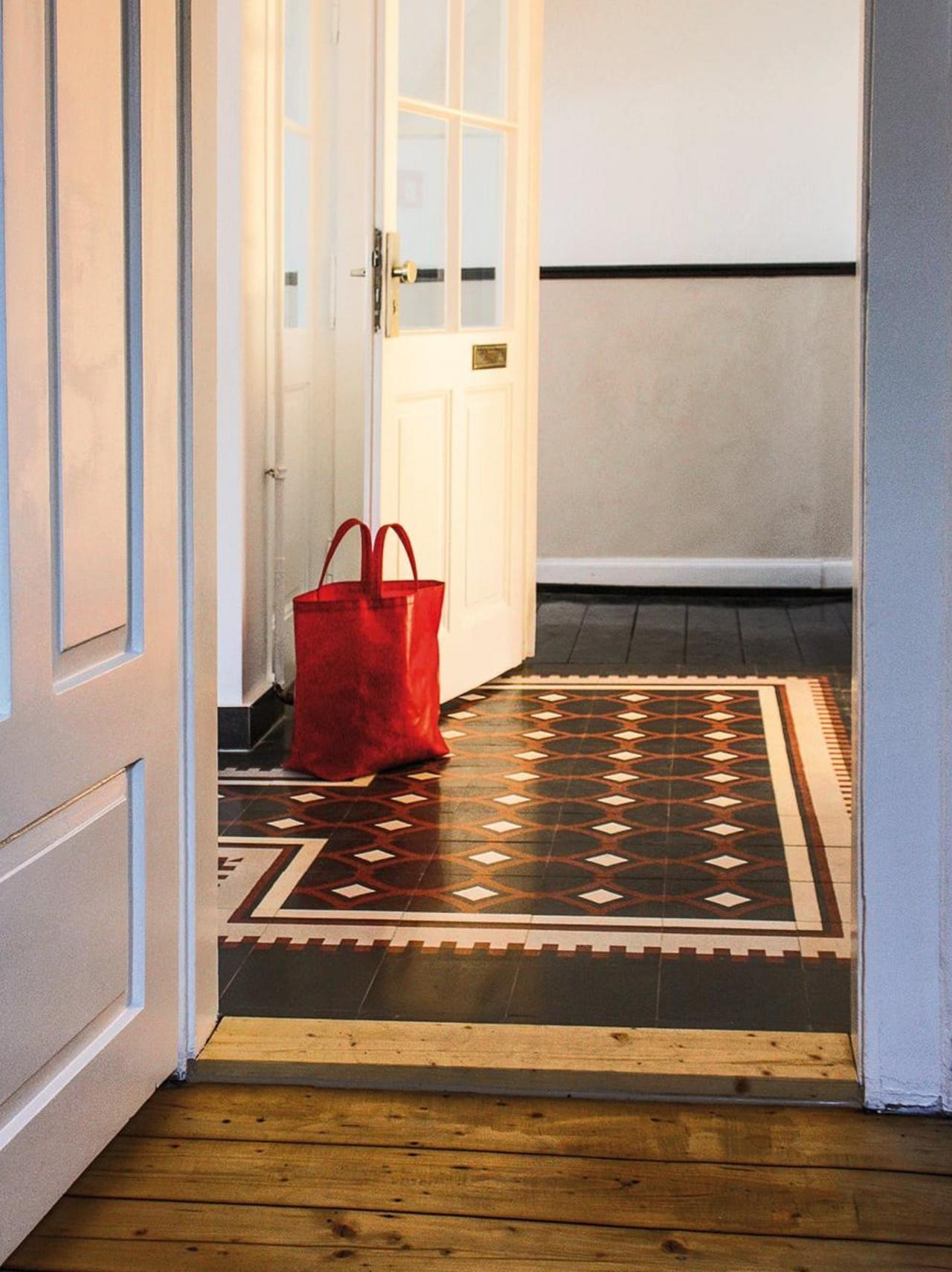 VIA terrazzo tiles in the old building in the hallway with wooden floorboards VIA terrazzo tiles in the old building in the hallway with wooden floorboards